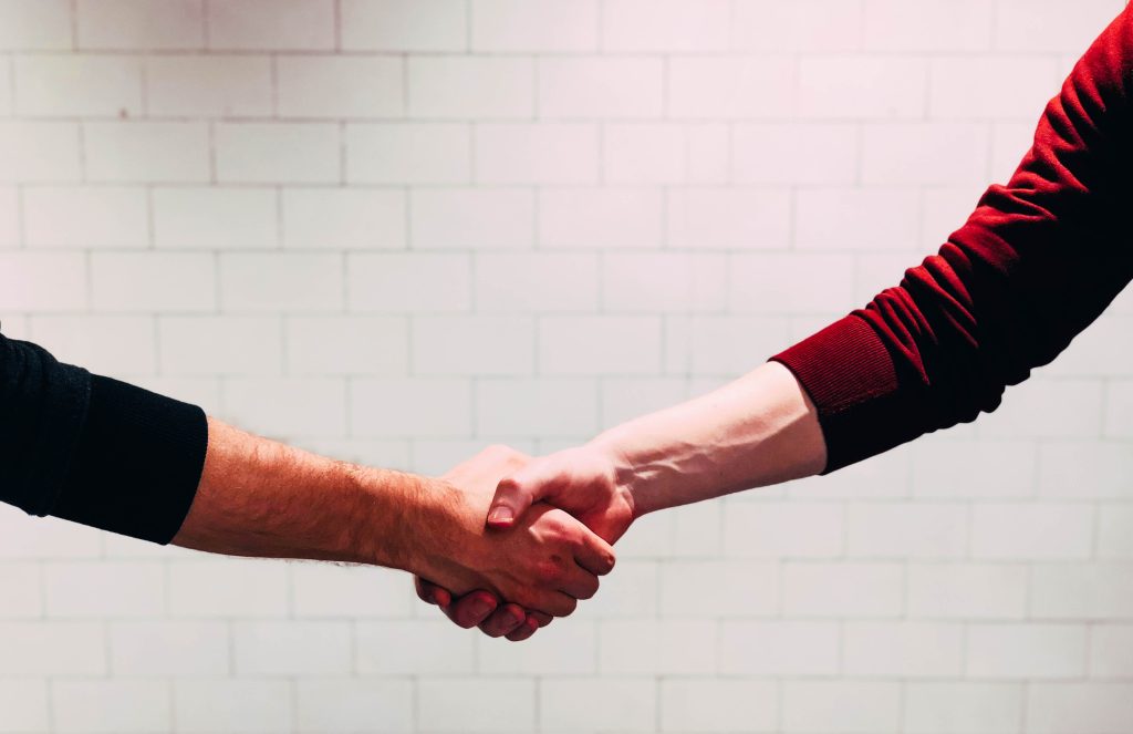 Two people shaking hands in agreement